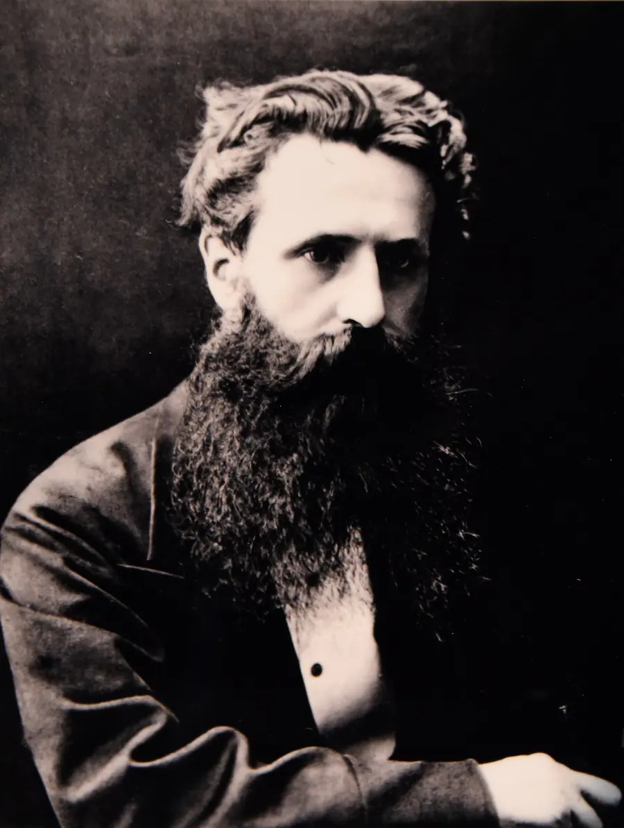 Victorian portrait photograph of a bearded man in a dark suit.