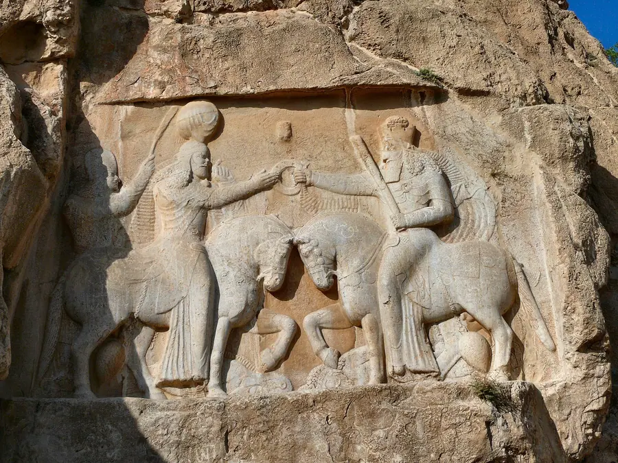 Monumental rock-cut relief of mounted figures carved into a cliff face.
